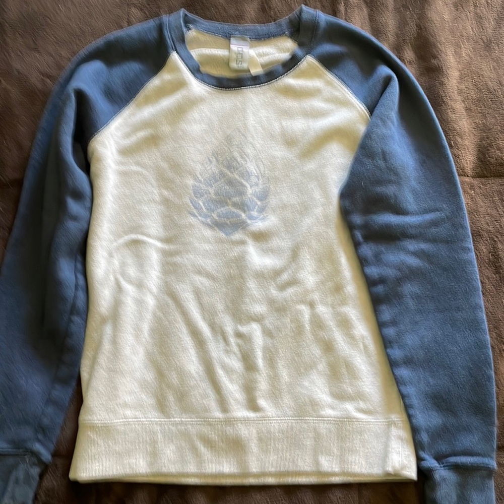 Stio baseball style sweatshirt with acorn logo. Blue/light heather gray.